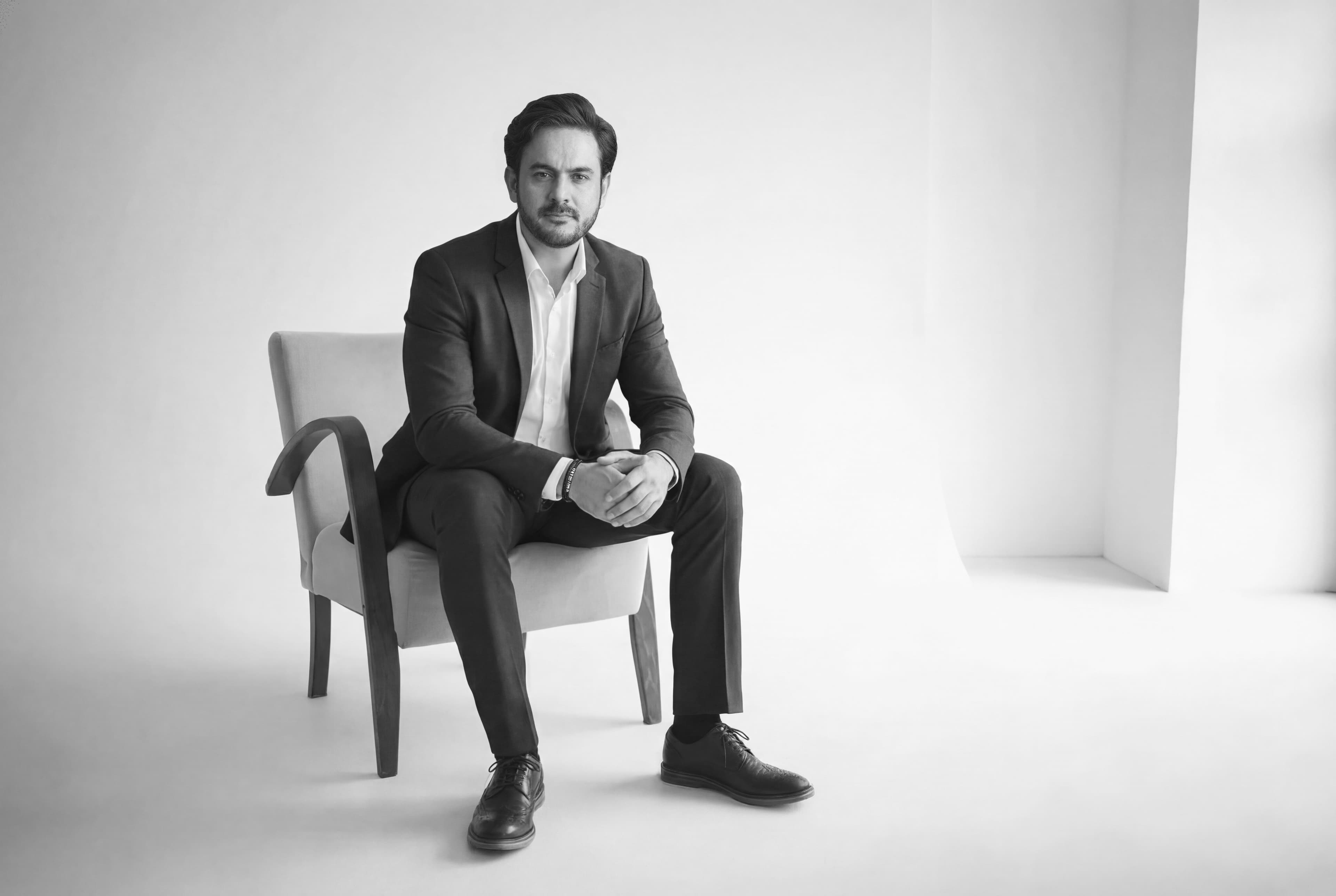 Alsim seated on a chair